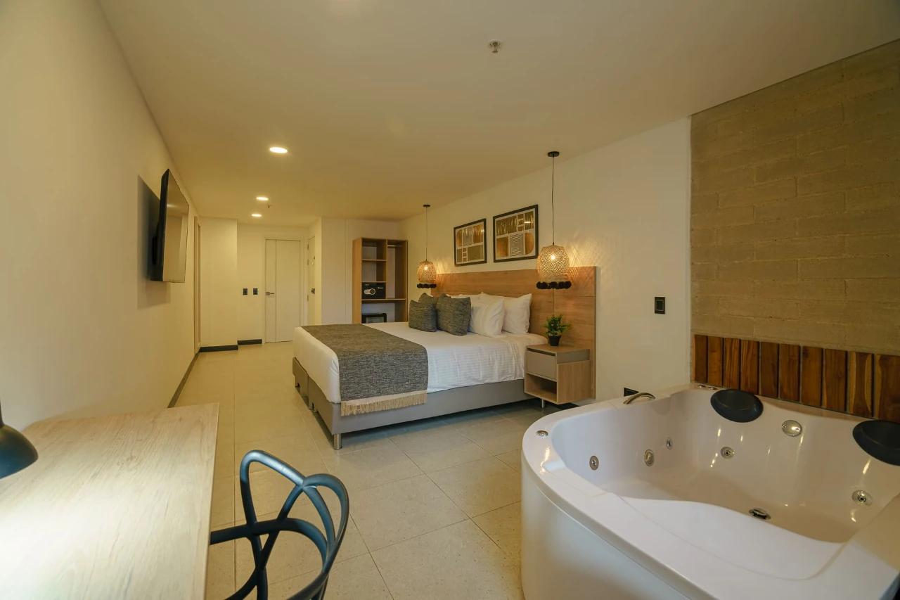 deluxe-room-first-class-hotel-medelin-bed-view-2.webp